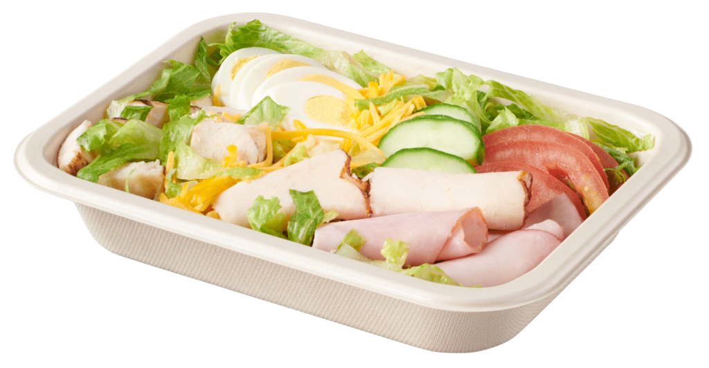 Single-compartment compostable salad tray with chef salad of lettuce, vegetables, sliced egg, cheese, chicken, turkey and ham.