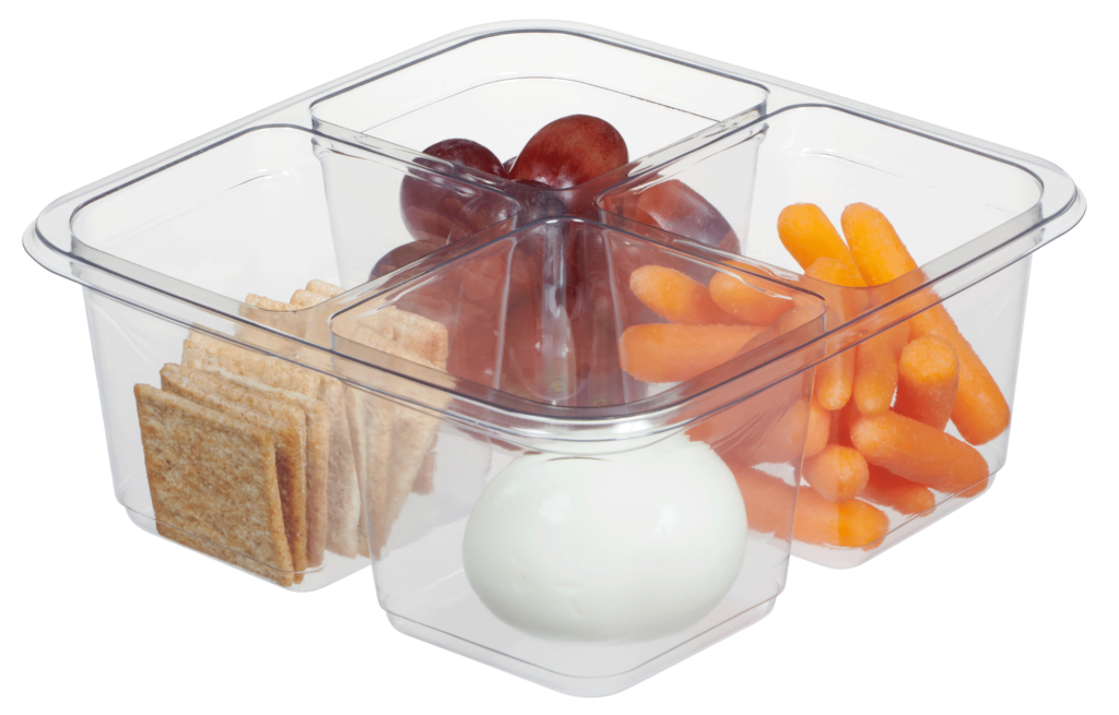 Clear plastic bento box with grapes, crackers, carrots, and hard-boiled egg in individual compartments.